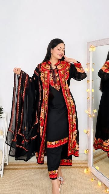 Kashmiri Kali collab reel thumbnail: creator Vidhi Bhargava in a black and red Aari-embroidered suit beside a mirror